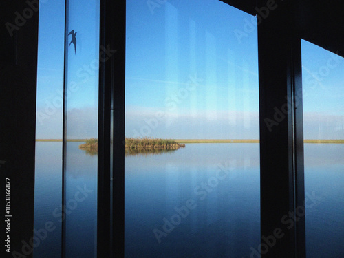 View from the window to the sea. Minimalist Lake view. Reflection in water. Nature backdrop. Beautiful natural flyer, card design. Nature Template for presentation or product
