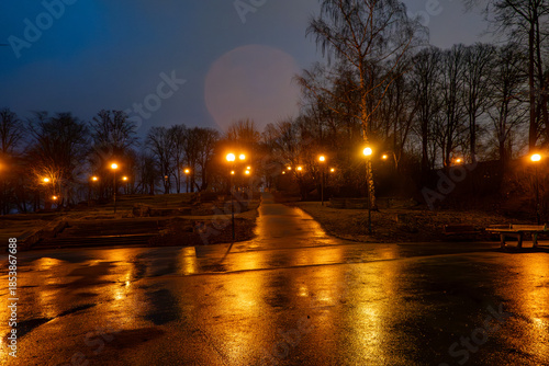 Tallinn, Estonia A view of an illuminated park at night in the rain.