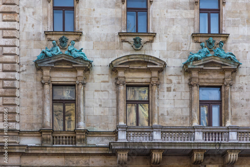 Obraz na plátně Horizontal close up eye level shot of a stone facade featuring classical windows