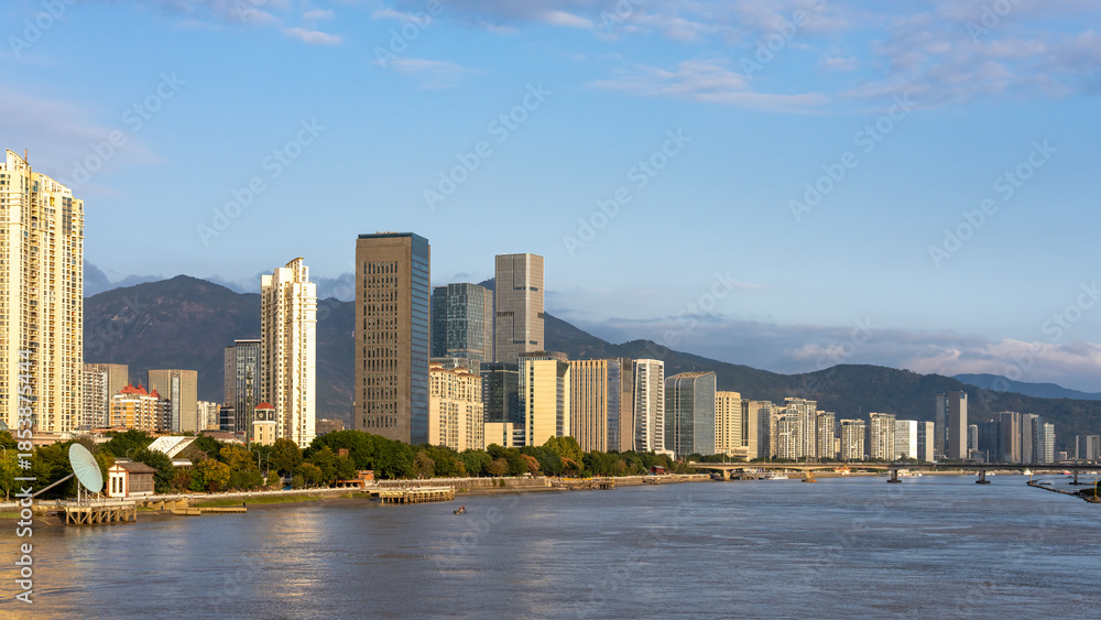 Fototapeta premium Modern City Skyline Along River with Skyscrapers