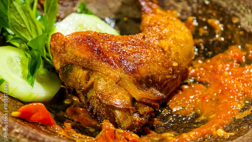 фотографія A deliciously cooked chicken dish smothered in a vibrant red sauce, served with