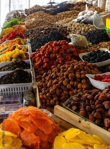 Market stall with an abundance of sweet dried fruits such as mangoes, papayas, apricots, dates, and plums, Chorsu Bazaar, Tashkent, Uzbekistan