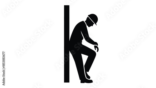 Silhouette of a tired construction worker leaning against a vertical structure taking a necessary rest break