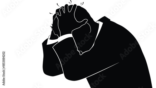 Silhouette of a stressed businessman clutching his head in a moment of intense emotional distress