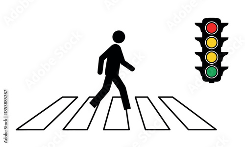 A pedestrian crossing a street at a crosswalk with a traffic light showing green high quality