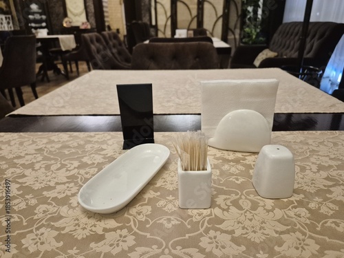 Cutlery and spices on a table in a restaurant