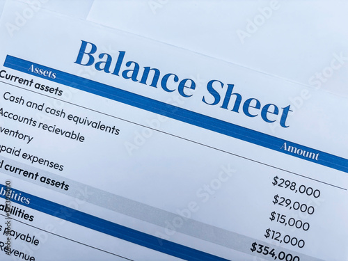 Balance sheet of a business concept showing on the paper top view backdrop.