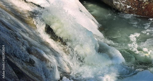 Wallpaper Mural Captured is a cascading waterfall, partially frozen, its waters a vibrant dance between solid ice and flowing stream, a blend of textures and contrasts. High Tatras National Park, Slovakia, Europe. Torontodigital.ca
