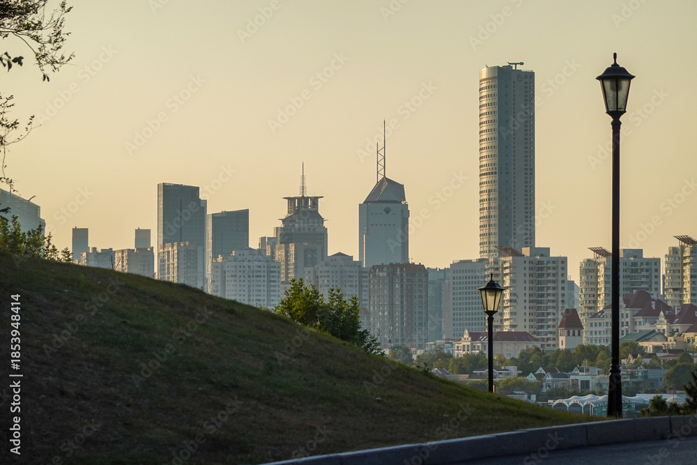 Fototapeta premium Urban Skyline With Tower In Warm Evening Light