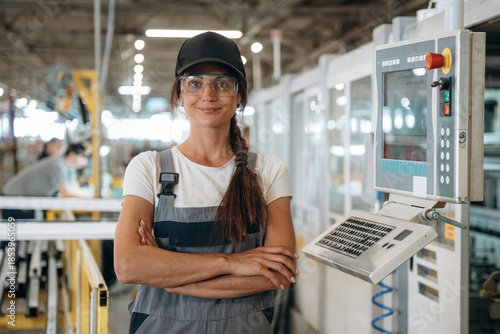 Canvas-taulu Modern window making factory, woman in professional uniform is standing