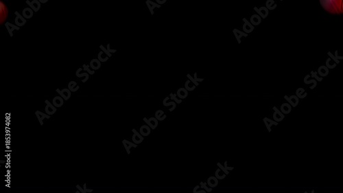 Clean basketballs falling with dramatic red and blue neon lighting. Sports transition with alpha channel for team versus screens.