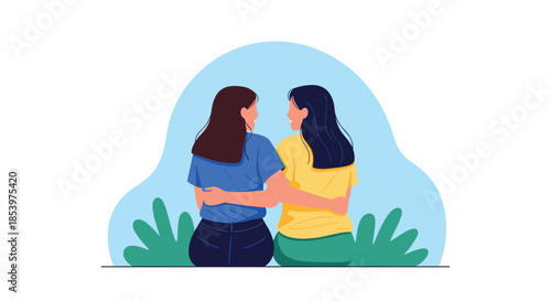 Rear view of two female friends sitting together on the grass with their arms around each other's shoulders enjoying a peaceful moment in nature.
