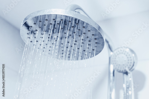 Photos Showerhead spraying clean water in a modern bathroom, symbolizing freshness, cle