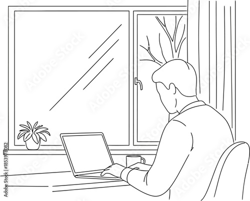 Man sitting at desk working on laptop in front of window with plants