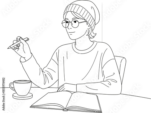 A person wearing glasses and a beanie sitting at a table with a cup and an open book