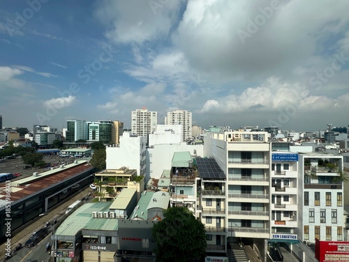 Rooftop view of the Ho Chi Minh City skyline featuring dense urban development, solar-equipped low-rise buildings, and modern skyscrapers, December 23, 2025. 
