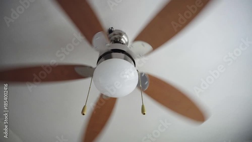 Turning On Ceiling Fan on White Background