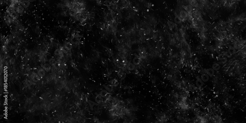 white paint drops on black background. dark background with monochrome ink wash details. messy snowflakes of different shapes.