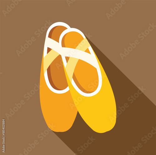 Yellow ballet shoes with long shadow representing dance and elegance