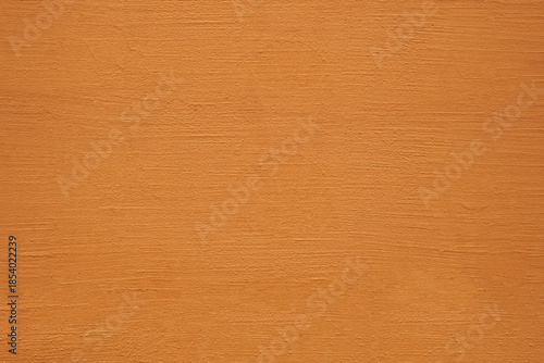 Textured background. Decorative plaster stucco concrete walls, external decoration of facade. Texture of yellow brown beige. Baked clay similar to cement or terracotta background. coating Rustic wall
