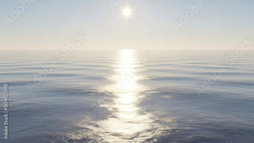 Shimmering sunlight path across the tranquil sea water.