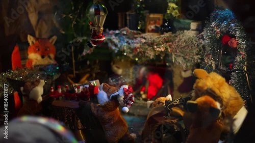 4K video of a New Year shop window display filled with various Christmas toys and festive decorations. Colorful ornaments, figurines, lights