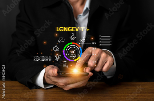 Businessman using smartphone with floating health and longevity icons, symbolizing wellness innovation, digital healthcare, and future lifestyle technology.