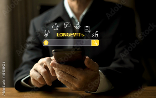 Businessman using smartphone with floating health and longevity icons, symbolizing wellness innovation, digital healthcare, and future lifestyle technology.