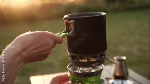 Girl Boiling Water For Dinner Using A Portable Gas Cooking System
