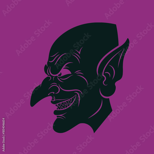 Silhouette of a grinning goblin face with pointed ears and nose.