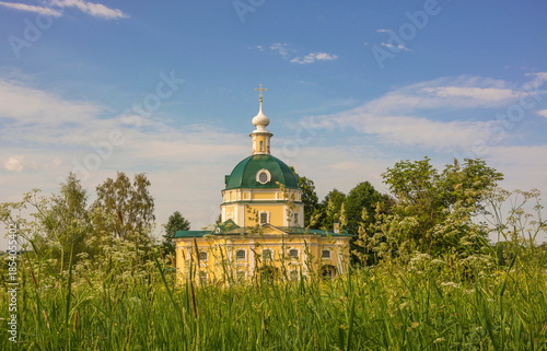 An ancient chapel in the middle of a summer meadow