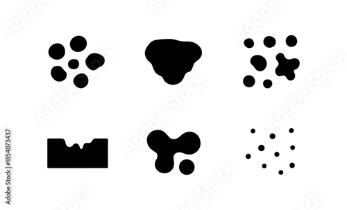 Collection of abstract black ink blots and stains on a white background