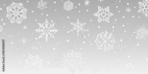 Delicate white snowflakes falling against a soft gradient background