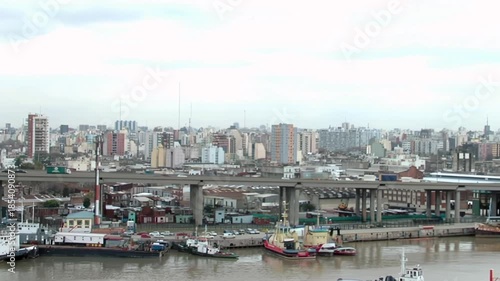 Blurred Container Truck Crossing Ricardo Balbin Highway Above Riachuelo River, Zooming Out To Buenos Aires Port, Argentina 