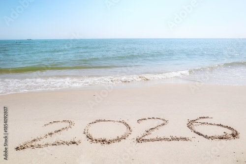 Happy New year 2026 with the waves beat at the beach and shell fragments. Soft focus. Holiday and nature concept.
