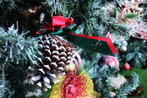 Christmas tree with decoration, pine seed, red cherry. Selective focus. Holiday, religion, and object concept,