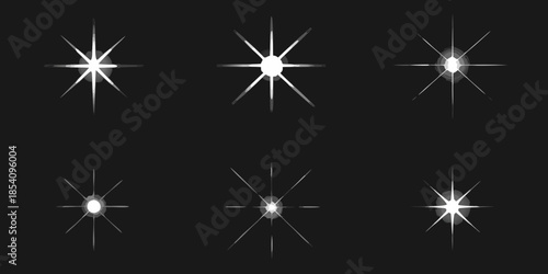 A collection of bright white starbursts and sparkling light effects on black