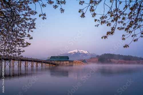Obraz na plátně Scenic view of wooden arch Tsuru-no-mai Bridge over Lake with Mountain and Blue