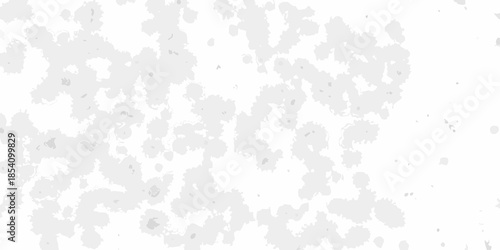 Abstract white background with scattered gray and black speckles and spots