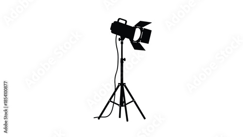 A single black silhouette of a stage spotlight on a tripod stand