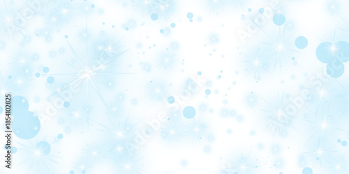 Shiny water drops on a blue bokeh background with festive snowflakes and bright Christmas stars create a cold winter holiday celebration pattern for a seasonal wallpaper design