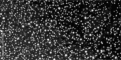 A stark black background scattered with numerous bright irregularly shaped white spots