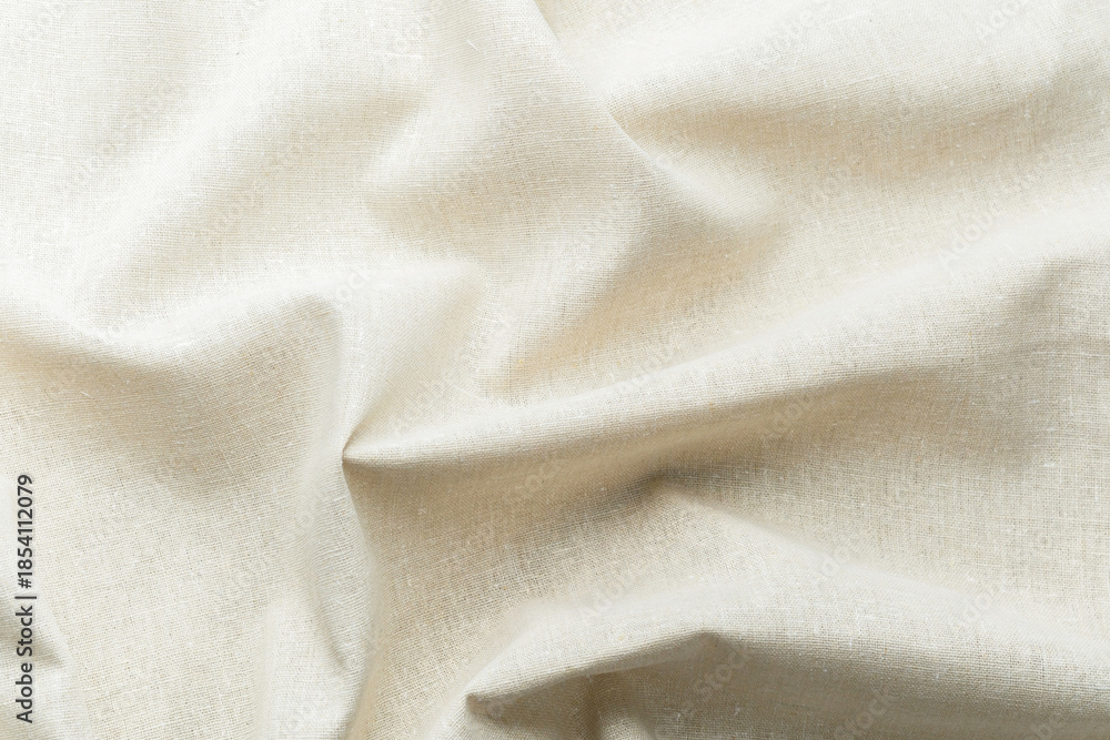 Fototapeta premium Natural beige fabric textile with soft folds and texture close up