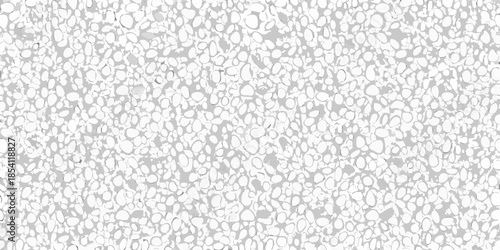 Close up view of a textured surface composed of small white rounded elements