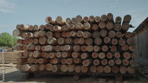 Pile of wooden square logs stacked on the construction site. Dolly camera