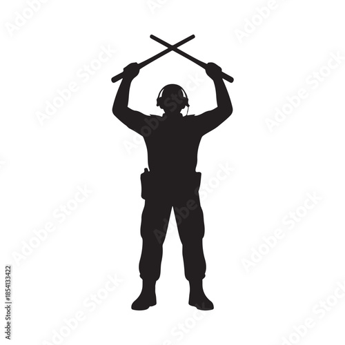 Silhouette of a person in military gear holding crossed batons overhead