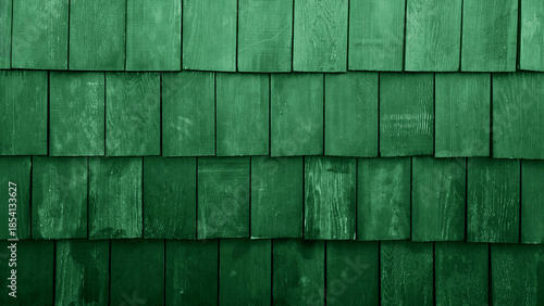 abstract green rustic wood shingles texture background. green weathered cedar shake wall siding. Grunge timber roof surface pattern with rough vertical grain details for architectural design.