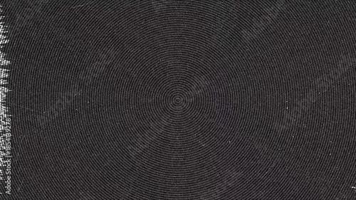 Close up of circular pattern on dark woven mat at Daytime