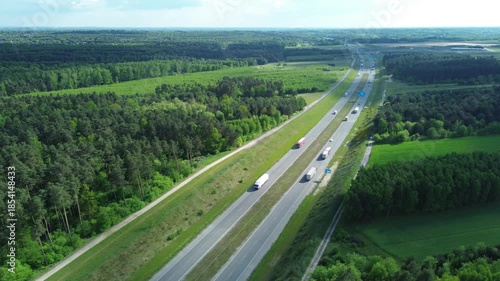Trucks and cars driving on an asphalt road in nature