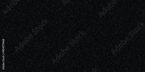 Dark speckled texture background with subtle grey and black granular pattern for abstract design elements and visual effects